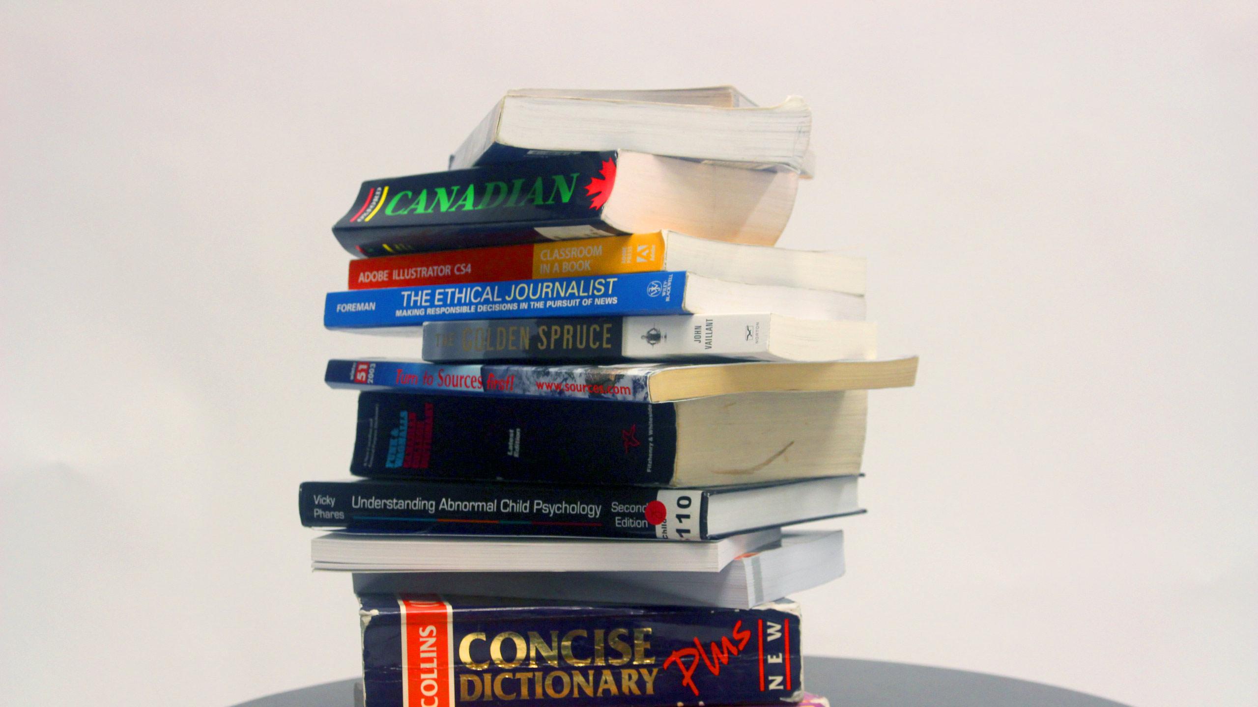 A stack of print textbooks.