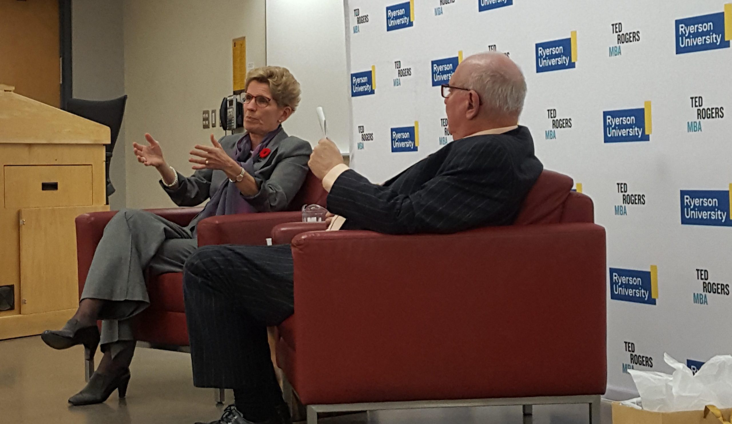 Kathleen Wynne sits in a chair next to Ralph Lean