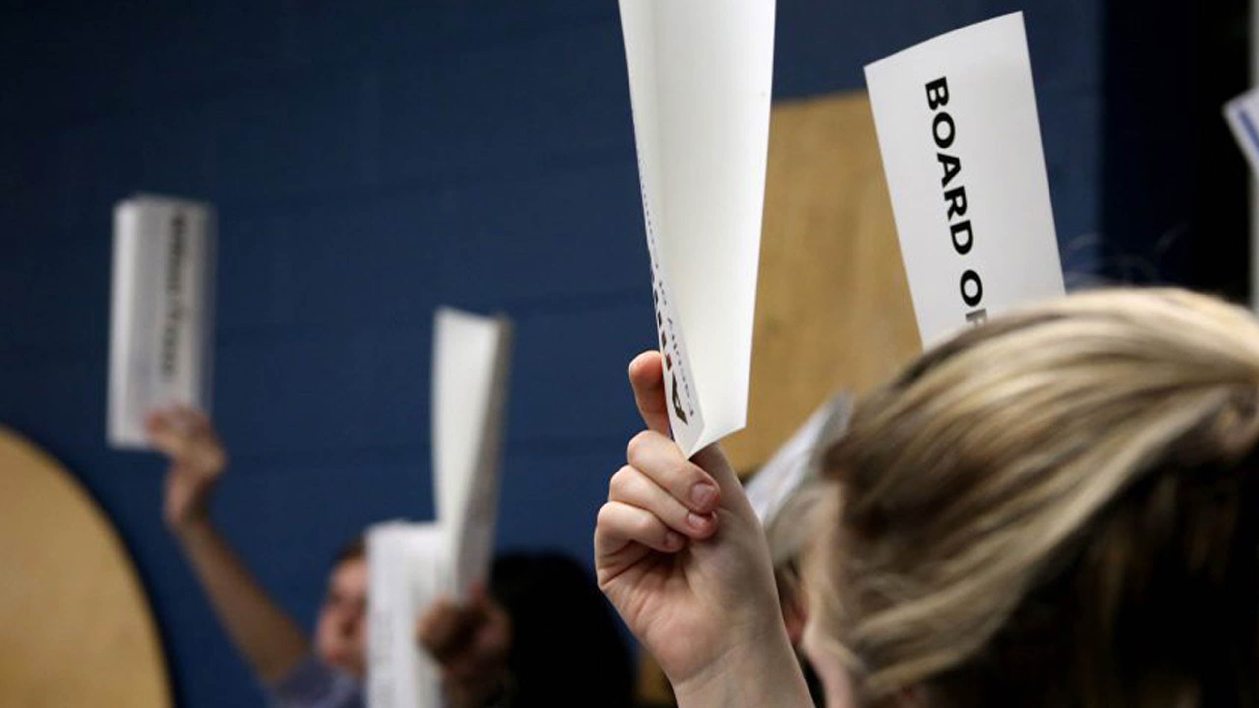 A BOD member holds up a sign