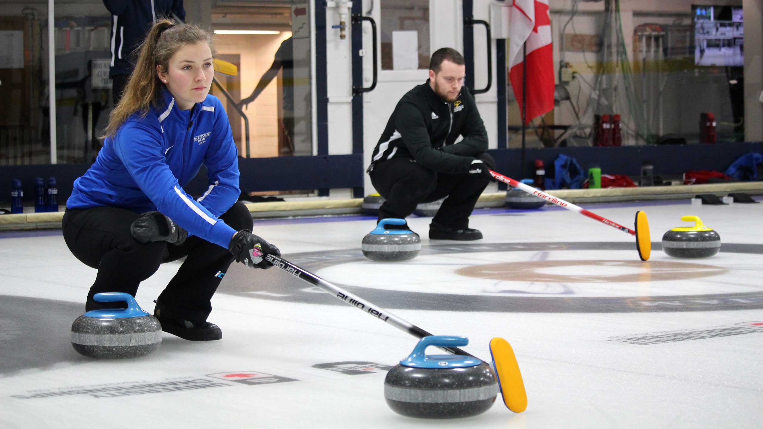 Two curlers lining up shot