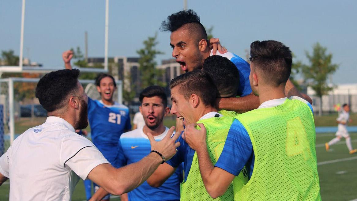 El-Chanti celebrates with teammates after scoring against the Ravens. (Photo Courtesy: Brent Smyth)