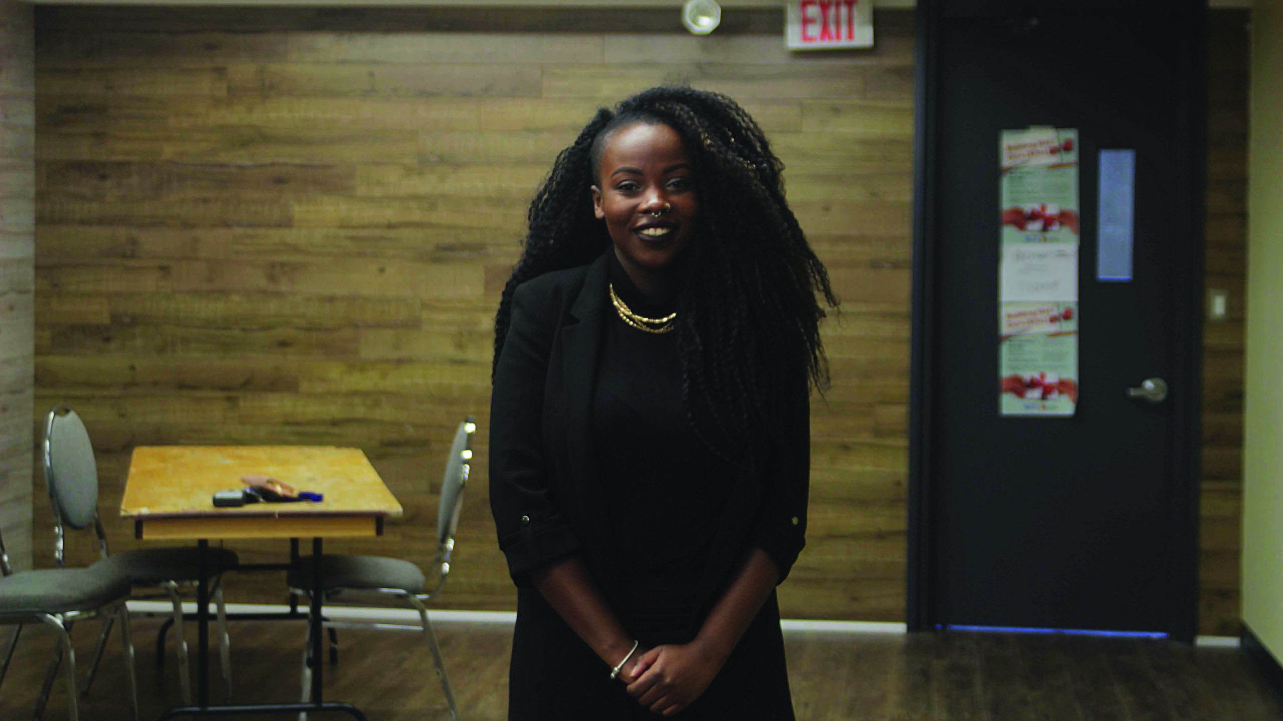 Susanne Nyaga stands against a wall in the space that will house the new wellness centre.