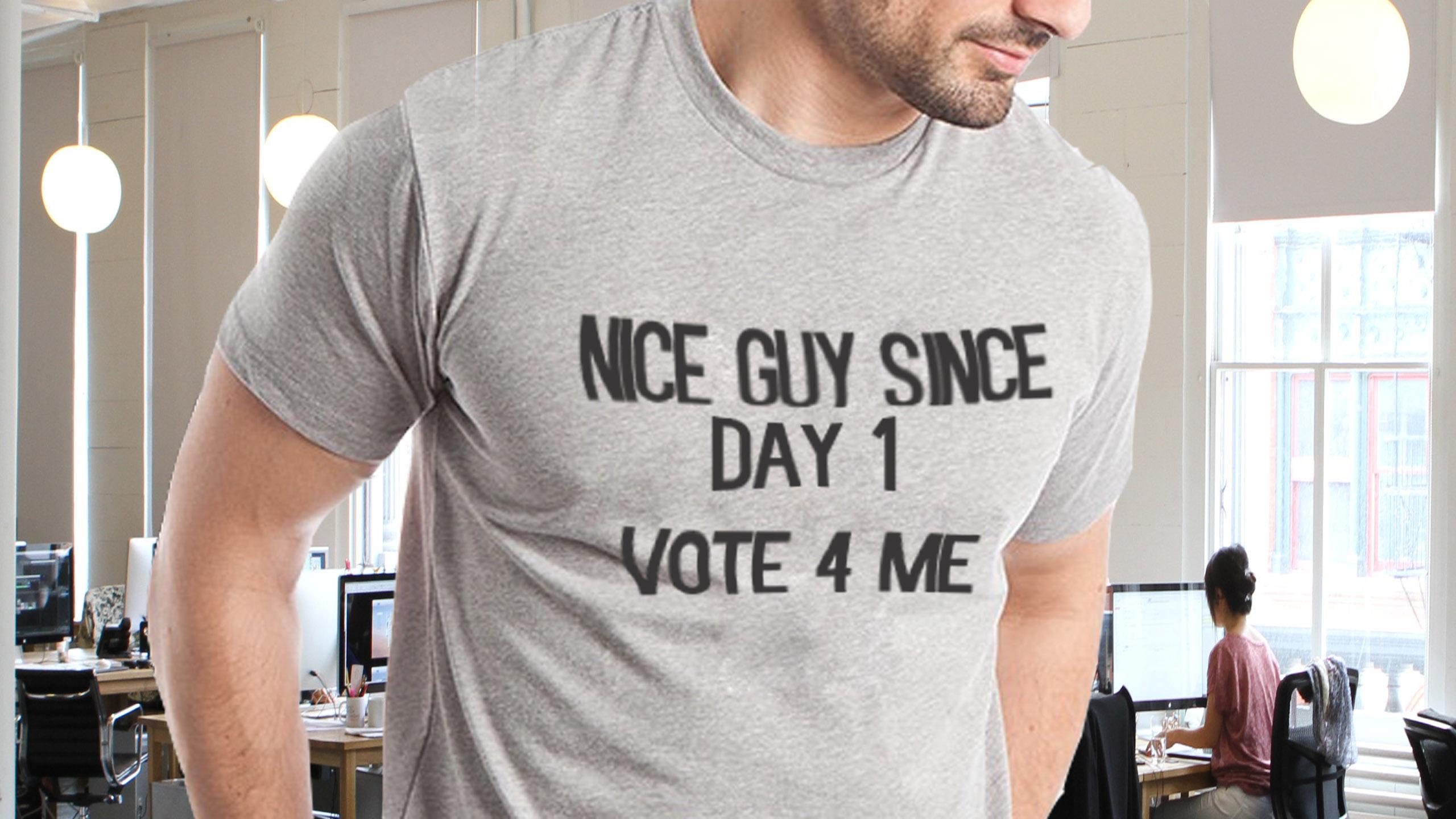 Man wearing shirt that reads "Nice guy since day one, vote for me"