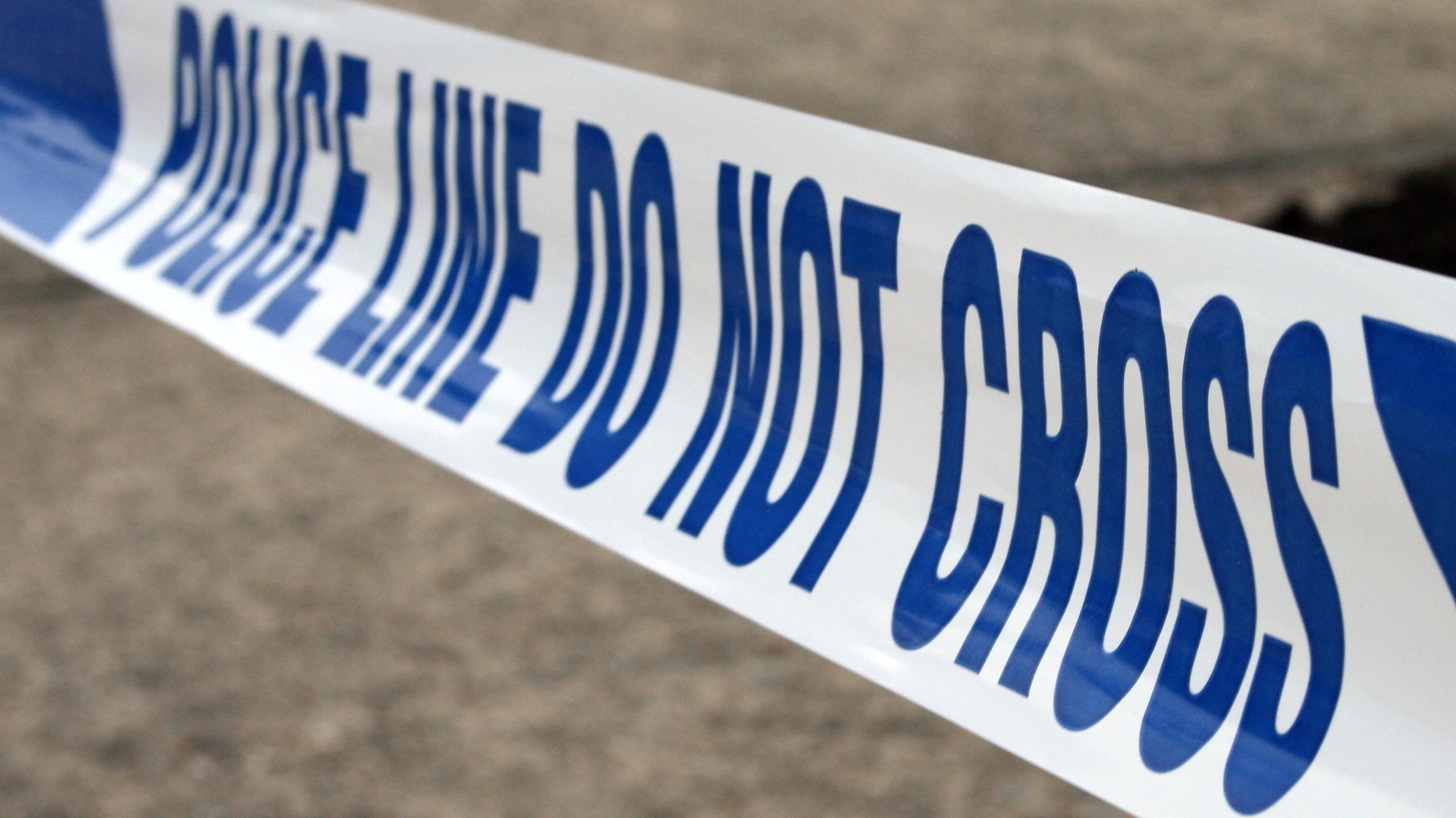 Police tape reading: Police line, do not cross