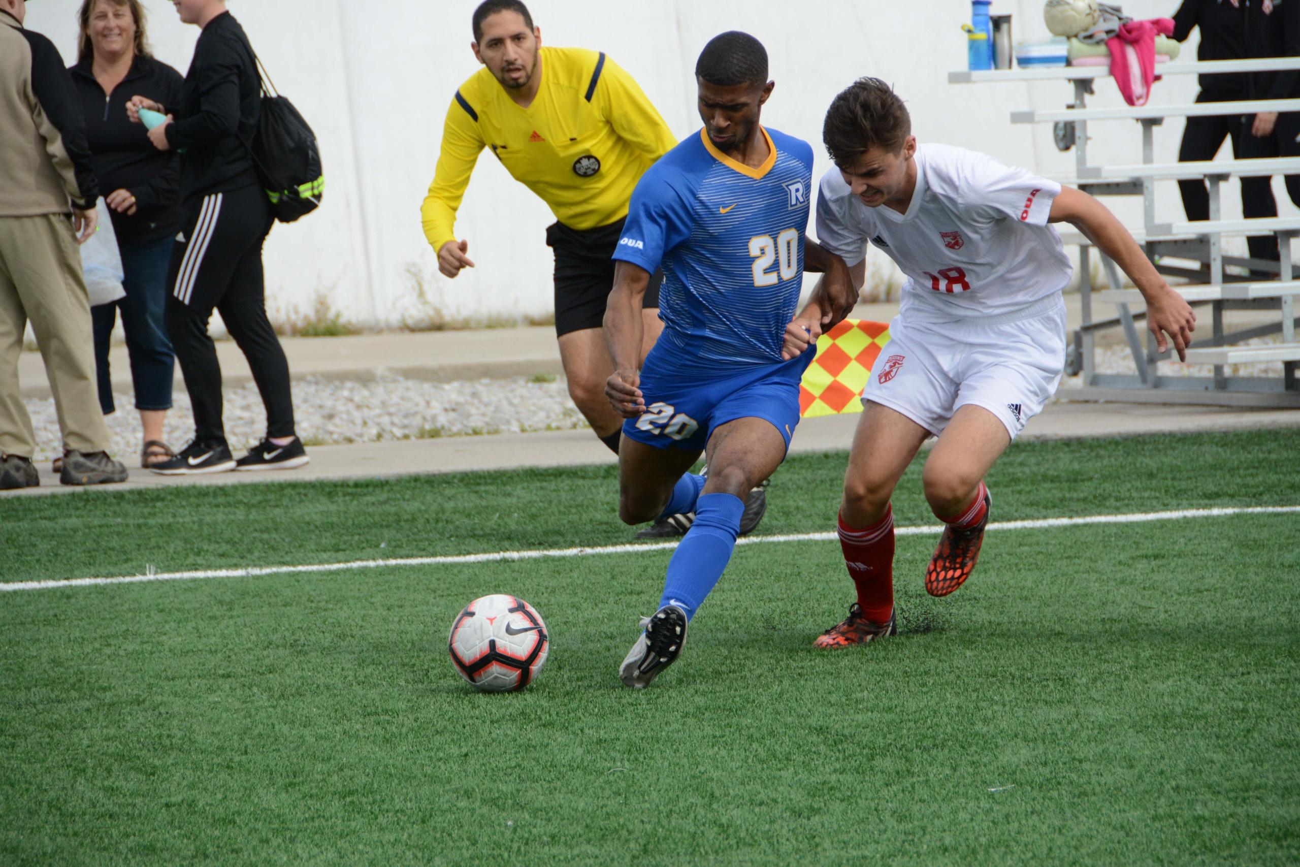 A photo of a male Ryerson student and a male student from another school going head to head in soccer game