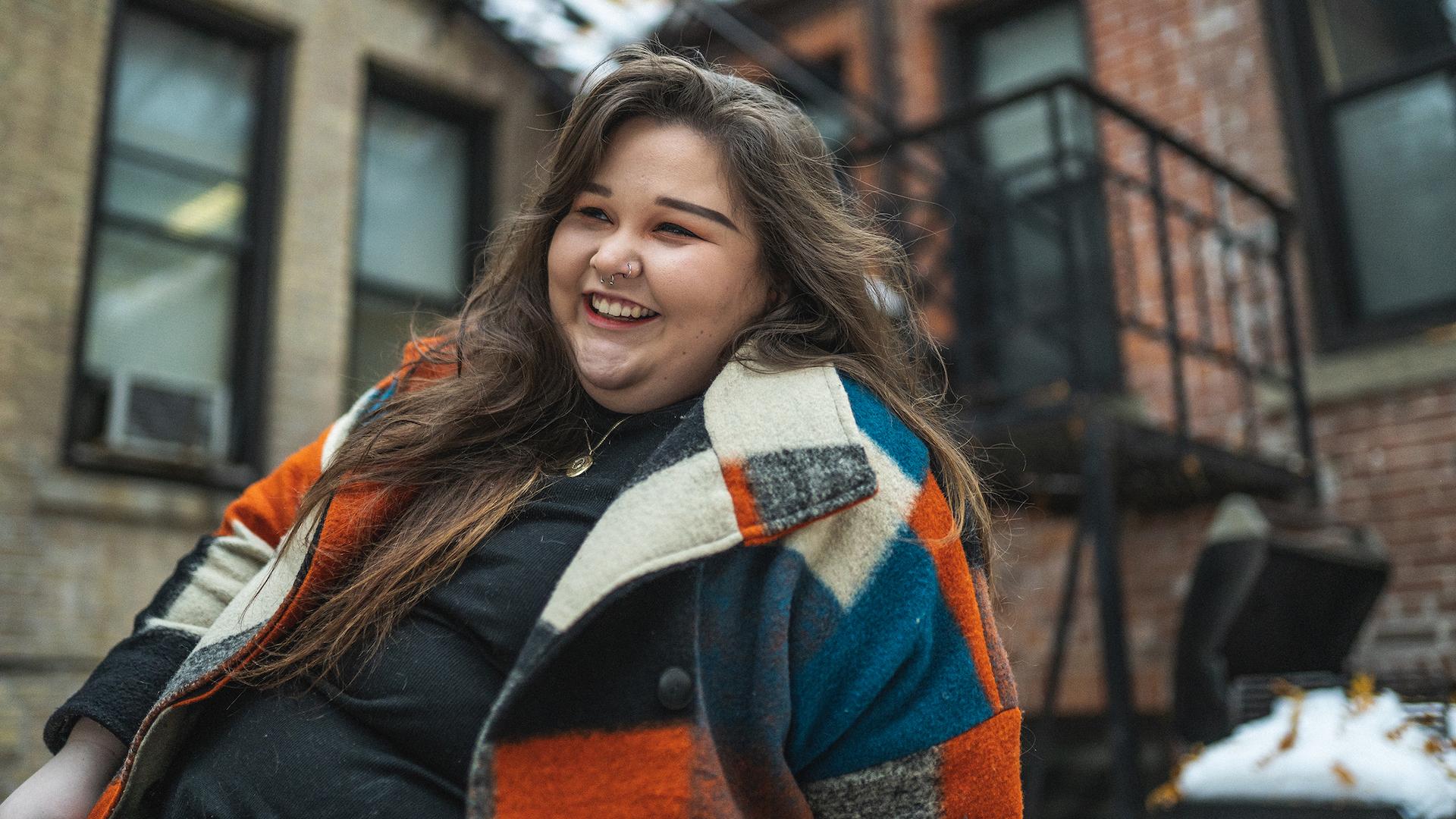 A person smiling in front of O'Keefe House