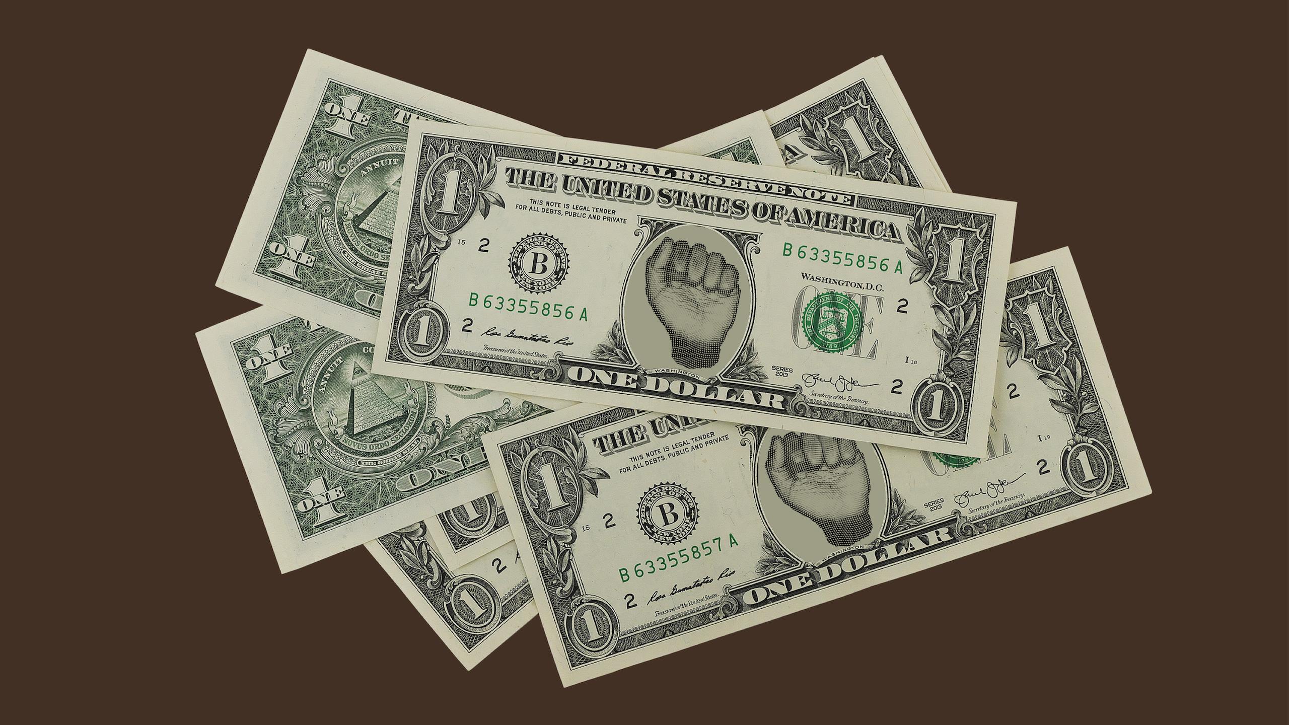 A stack of green one dollar bills with a raised fist in the middle of the bills.