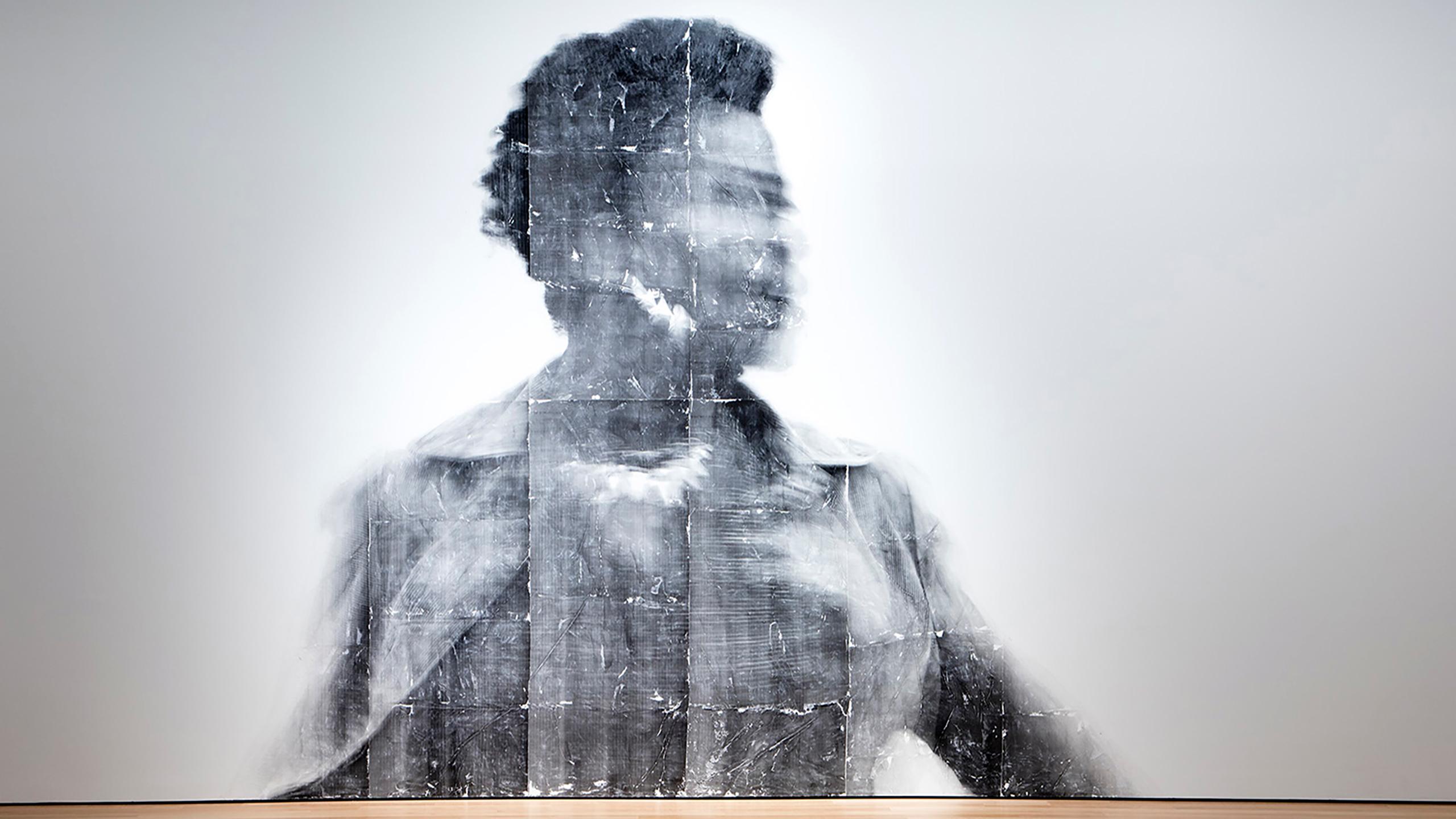 A photo of a Black woman projected on a wall