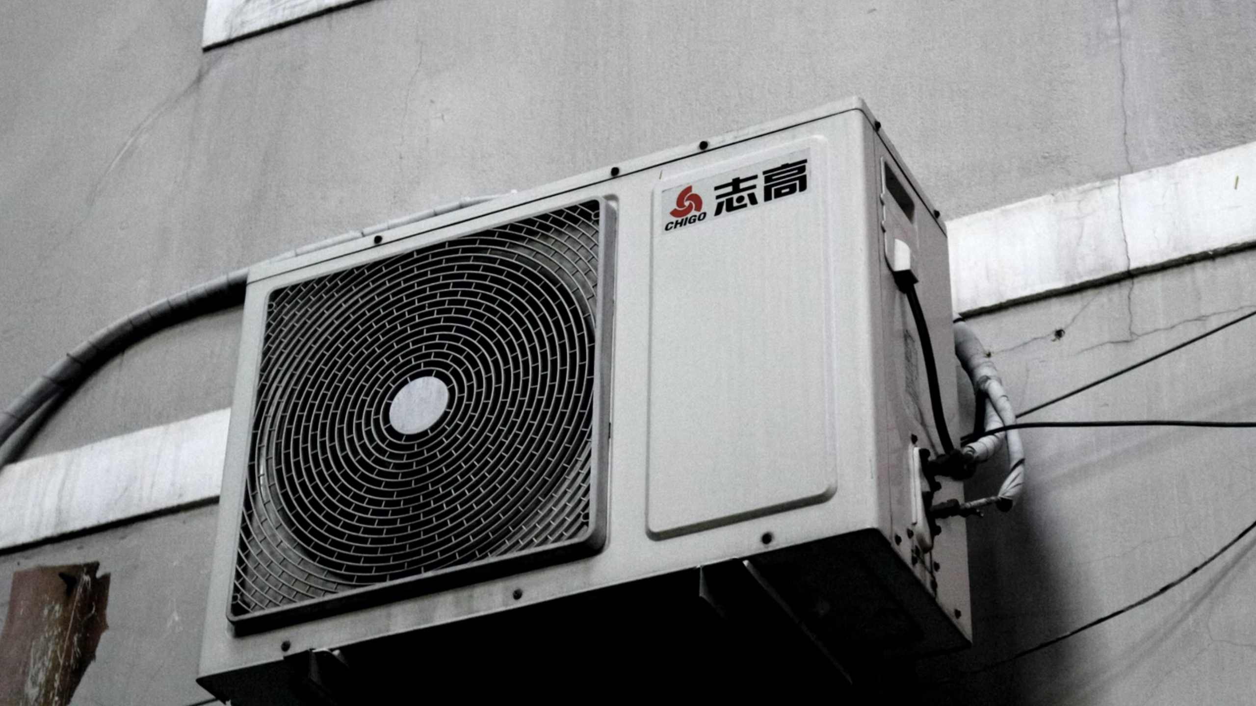 A black and white photo of an air filter outside of a building