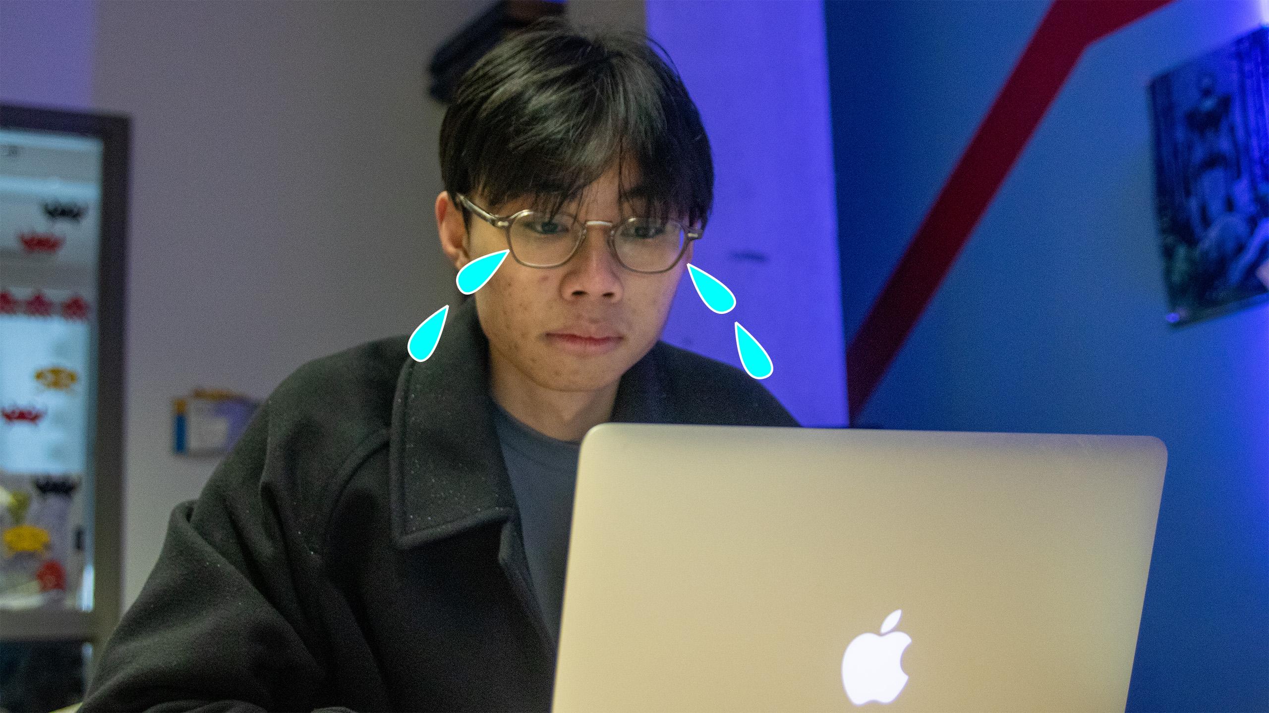 a student sitting at their computer with a graphic of tears coming out of their eyes