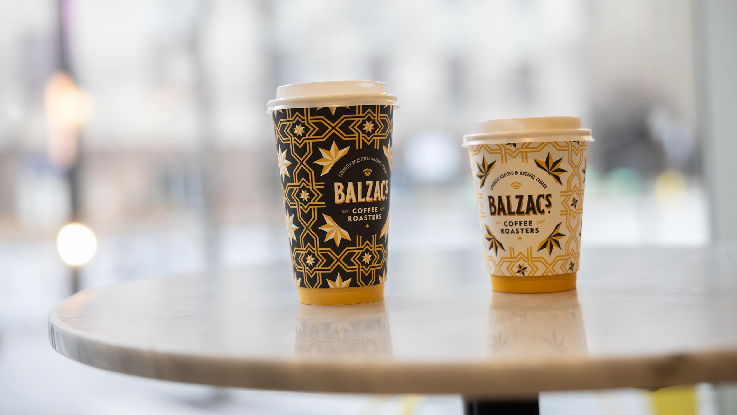Two Coffee Cups sit on a table