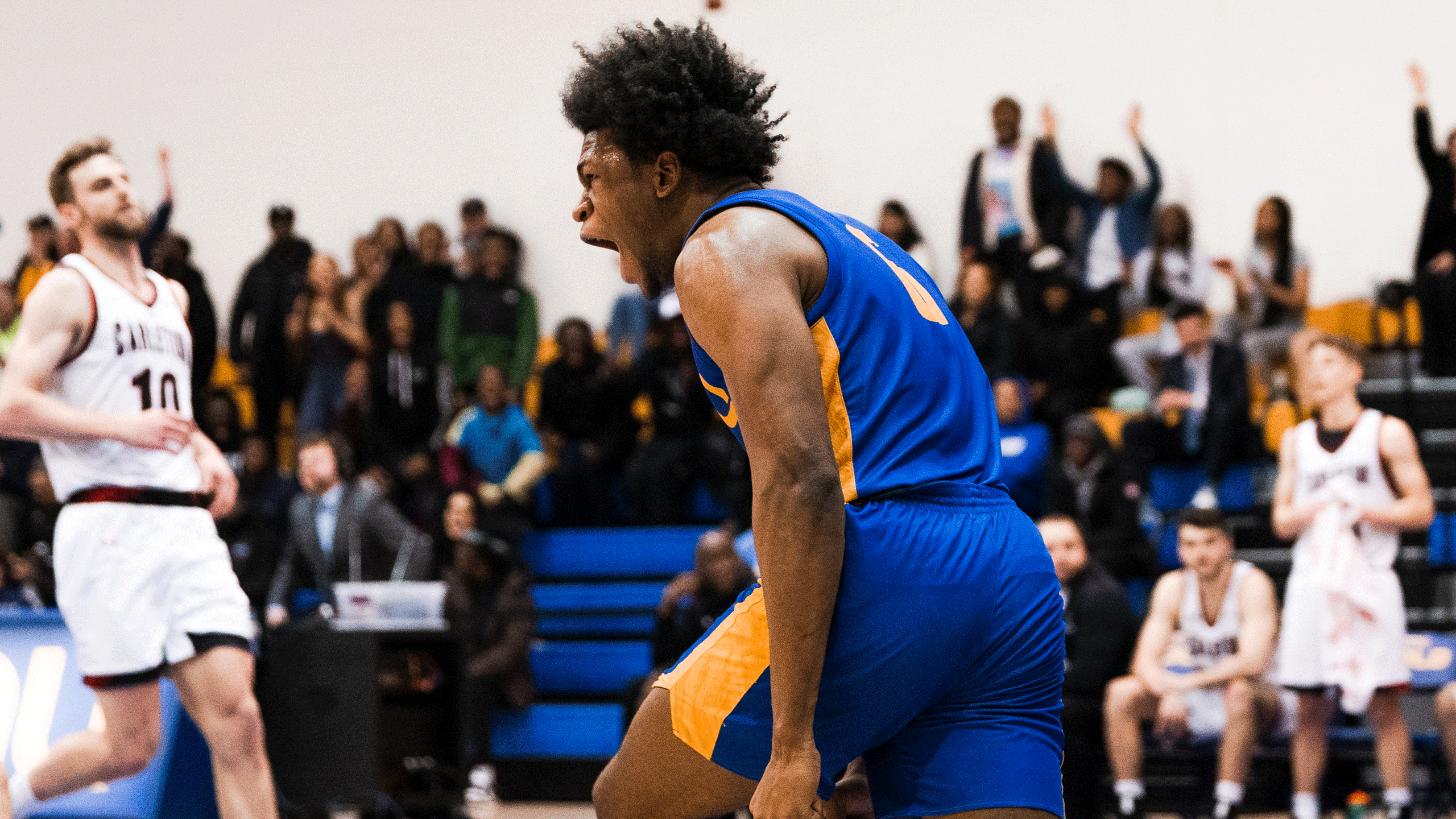 TMU Bold basketball player David Walker celebrates