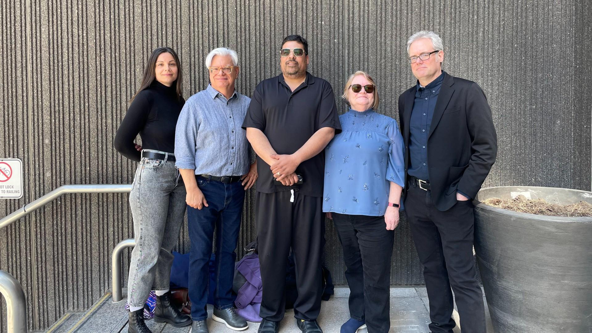 Five people standing beside each other