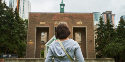 A student stands in front of Toronto Metropolitan University’s (TMU) Campus.