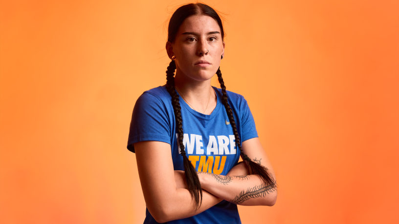 Volleyball player poses with her arms crossed