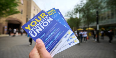TMSU pamphlet is held up at Toronto Metropolitan University