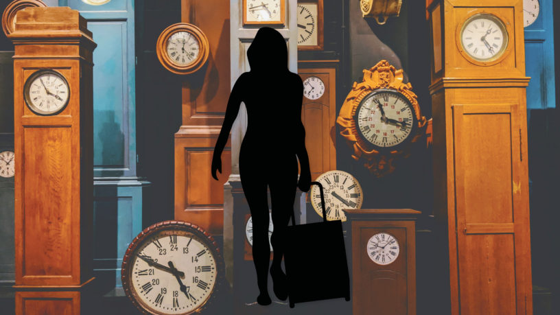 silhouette of person with suitcase walking in front of clocks