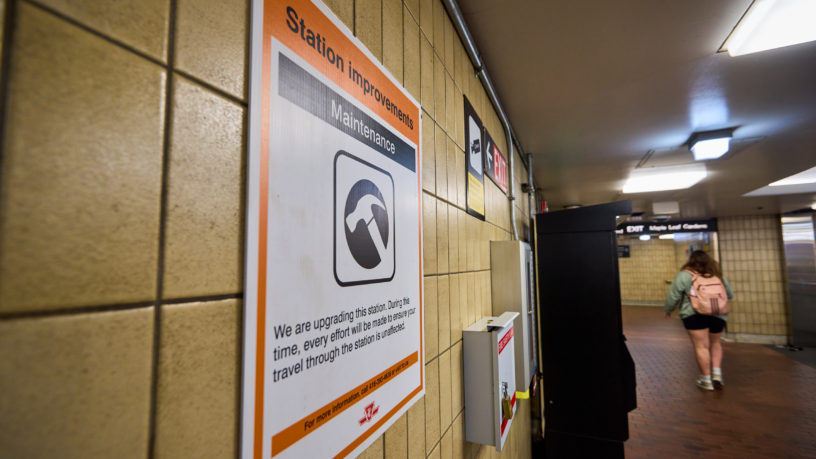 Construction sign on tiled wall of subway station