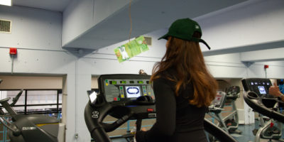 Person on a treadmill with a twenty dollar bill dangling in front of them