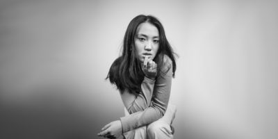 Christina Kennedy poses on a grey background