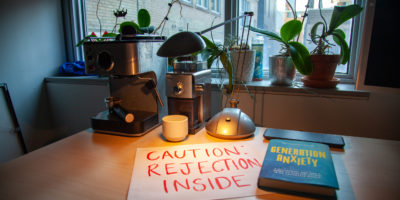 Gloomy room with a letter of rejection and anxiety book on the desk