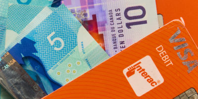 close up of cash and debit card