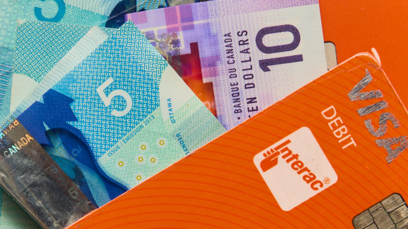 close up of cash and debit card