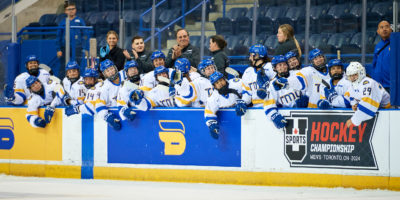 The TMU women's hockey team on the bench at the Mattamy Athletic Centre