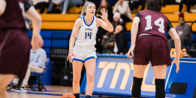 TMU Bold basketball player Kaillie Hall dribbles a basketball against an opposing player at the Mattamy Athletic Centre