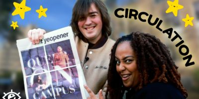 Two efditors from the eyeopener holding a new copy on the paper smiling, to the right is the words "circulation" with yellow stars surrounding the perimeter