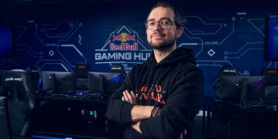 Person standing in front of gaming tables and chairs