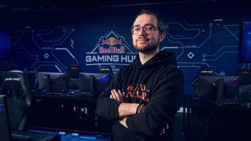 Person standing in front of gaming tables and chairs