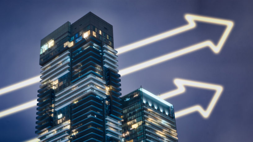 Two condo buildings with increasing arrows going through buildings
