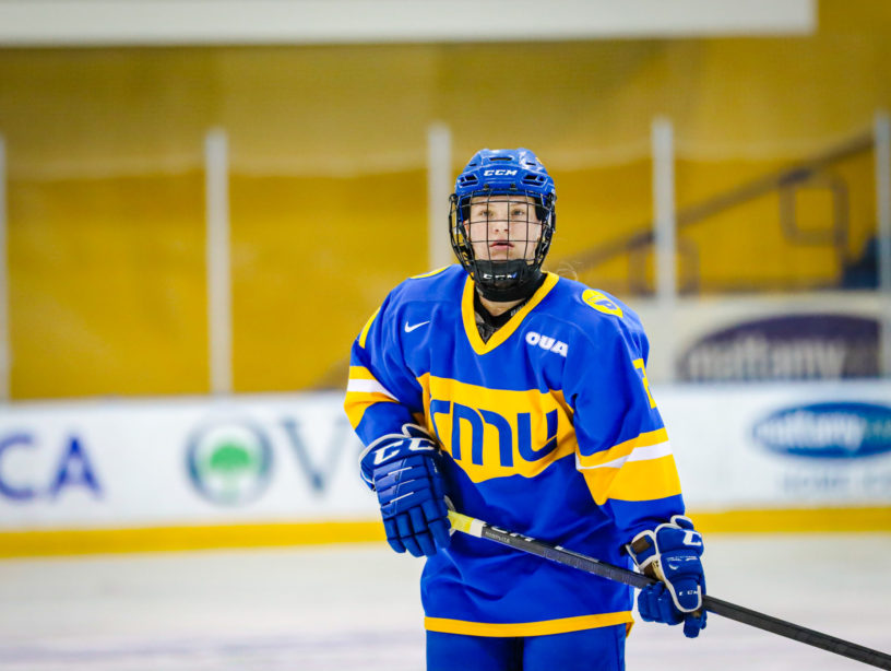 TMU women's hockey player Emily Baxter stands on the ice