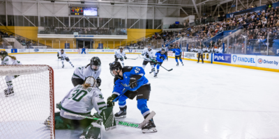 PWHL Toronto forward Blayre Turnbull fights for the puck near PWHL Boston's goalie Emma Söderberg and another Boston player