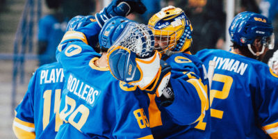 TMU men's hockey players Kyle Bollers and Kai Edmonds hug each other after a win