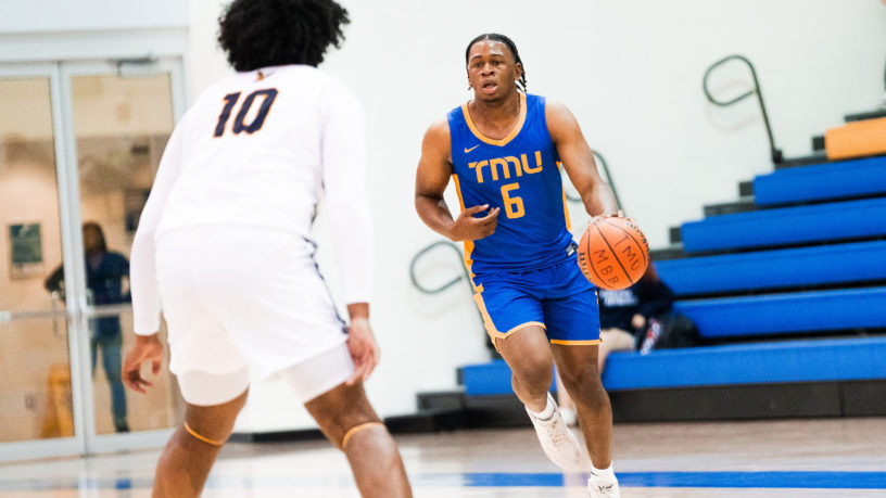 TMU men's basketball player David Walker dribbles the ball up the court