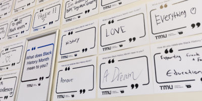 Posters of written answers to the question "What does Black History Month mean to you?" hang on the wall at the Mattamy Athletic Centre