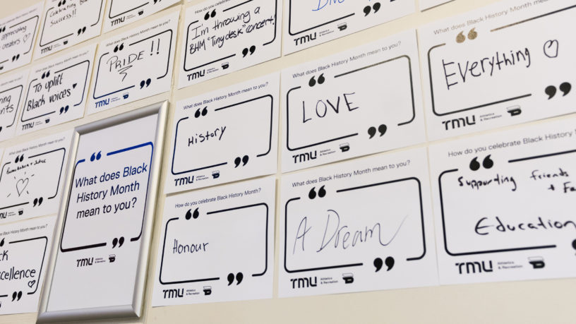 Posters of written answers to the question "What does Black History Month mean to you?" hang on the wall at the Mattamy Athletic Centre