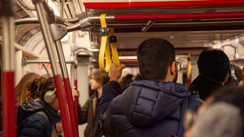 Person holding onto handstrap on TTC subway