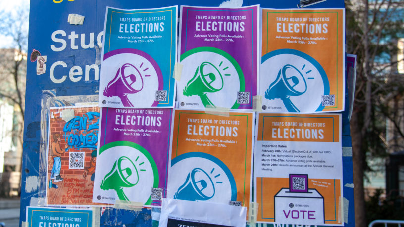 Posters saying "Elections" in differing covers on building entrance