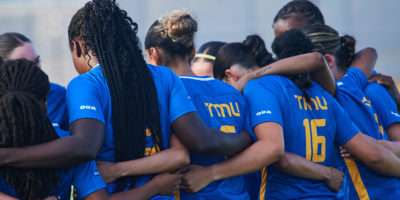 Bold players hugging while the Canadian anthem is playing