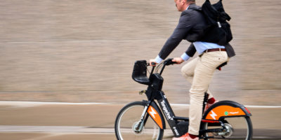 MAN BIKING FAST CITY BIKE