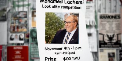 A poster along a blurred out wall, with a photo of Mohamed Lachemi reading "Mohamed Lachemi Look alike competition."