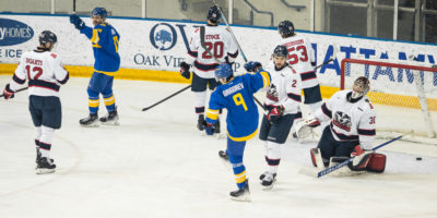 Daniil Grigorev pumps his fist to celebrate a goal in front of the Brock Badgers net