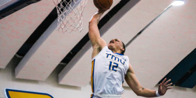 Aaron Rhooms scoring a layup with his right hand