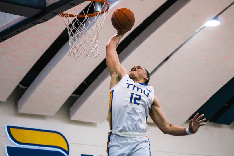 Aaron Rhooms scoring a layup with his right hand