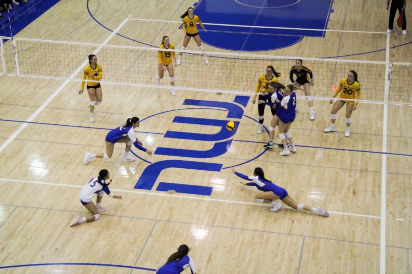 The TMU Bold women's volleyball aiming to reach the ball after a kill attempt