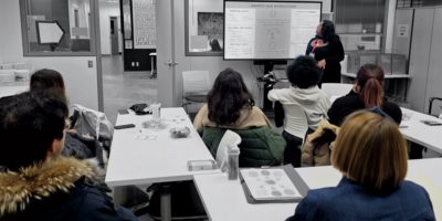 A group of students watch a presentation.
