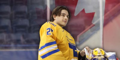 Kai Edmonds from the TMU Bold men's hockey team with the Canadian flag behind him